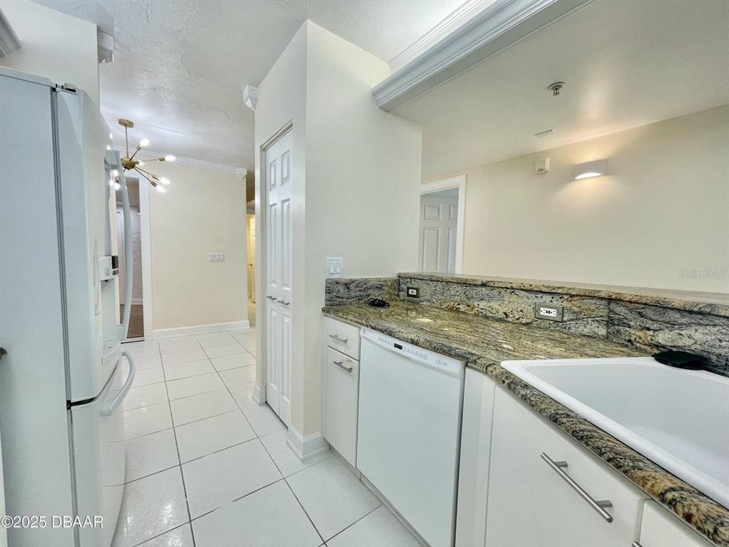 4575 South Atlantic Avenue, Unit 6203 Ponce Inlet, FL 32127 - Photo 16 of 34 a view of a kitchen cabinets and a stove top oven