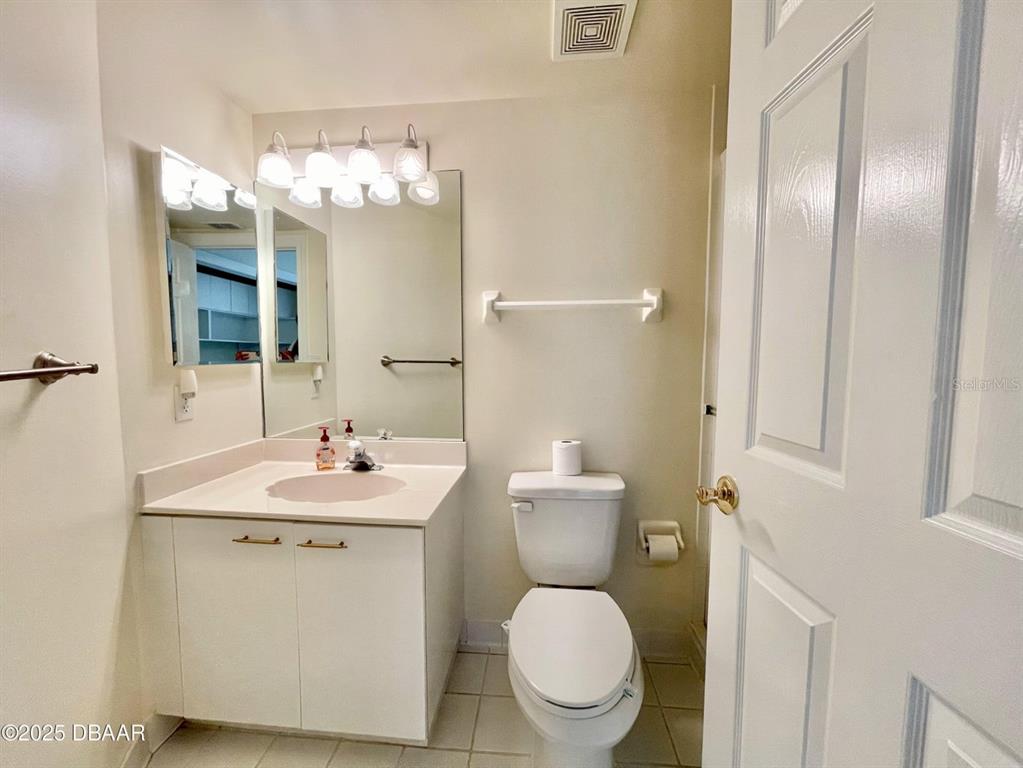 4575 South Atlantic Avenue, Unit 6203 Ponce Inlet, FL 32127 - Photo 24 of 34 a bathroom with a sink toilet and mirror