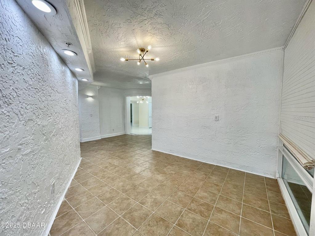4575 South Atlantic Avenue, Unit 6203 Ponce Inlet, FL 32127 - Photo 27 of 34 a view of a hallway with chandelier