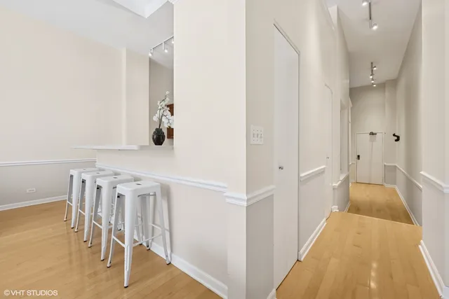 a living room with furniture and a painting on the wall