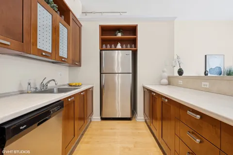 a kitchen with stainless steel appliances kitchen island a stove a sink and a refrigerator