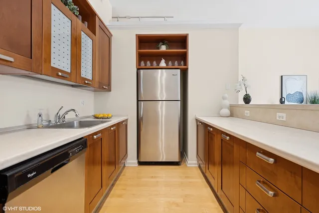 a kitchen with stainless steel appliances kitchen island a stove a sink and a refrigerator