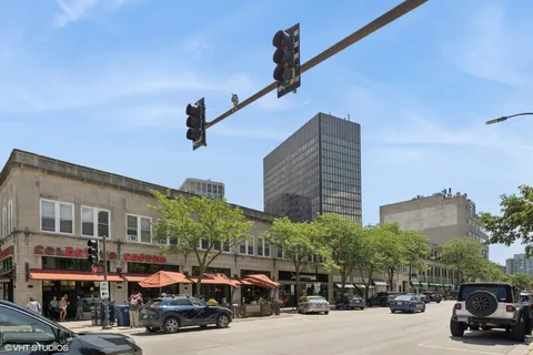 a city street lined with parked cars and buildings