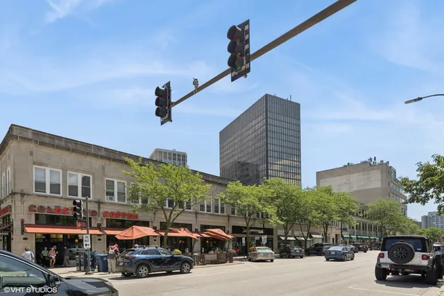 a city street lined with parked cars and buildings