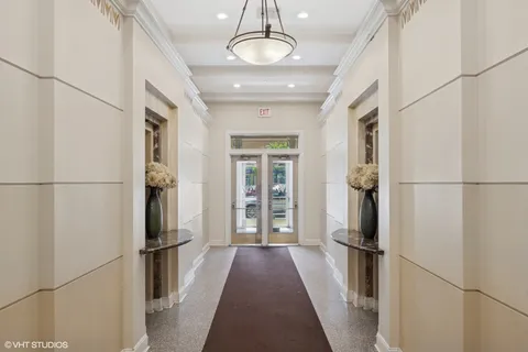 a view of a refrigerator in kitchen and an empty room