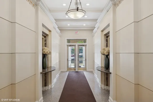 a view of a refrigerator in kitchen and an empty room
