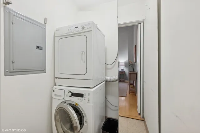 a living room with furniture a flat screen tv and a potted plant