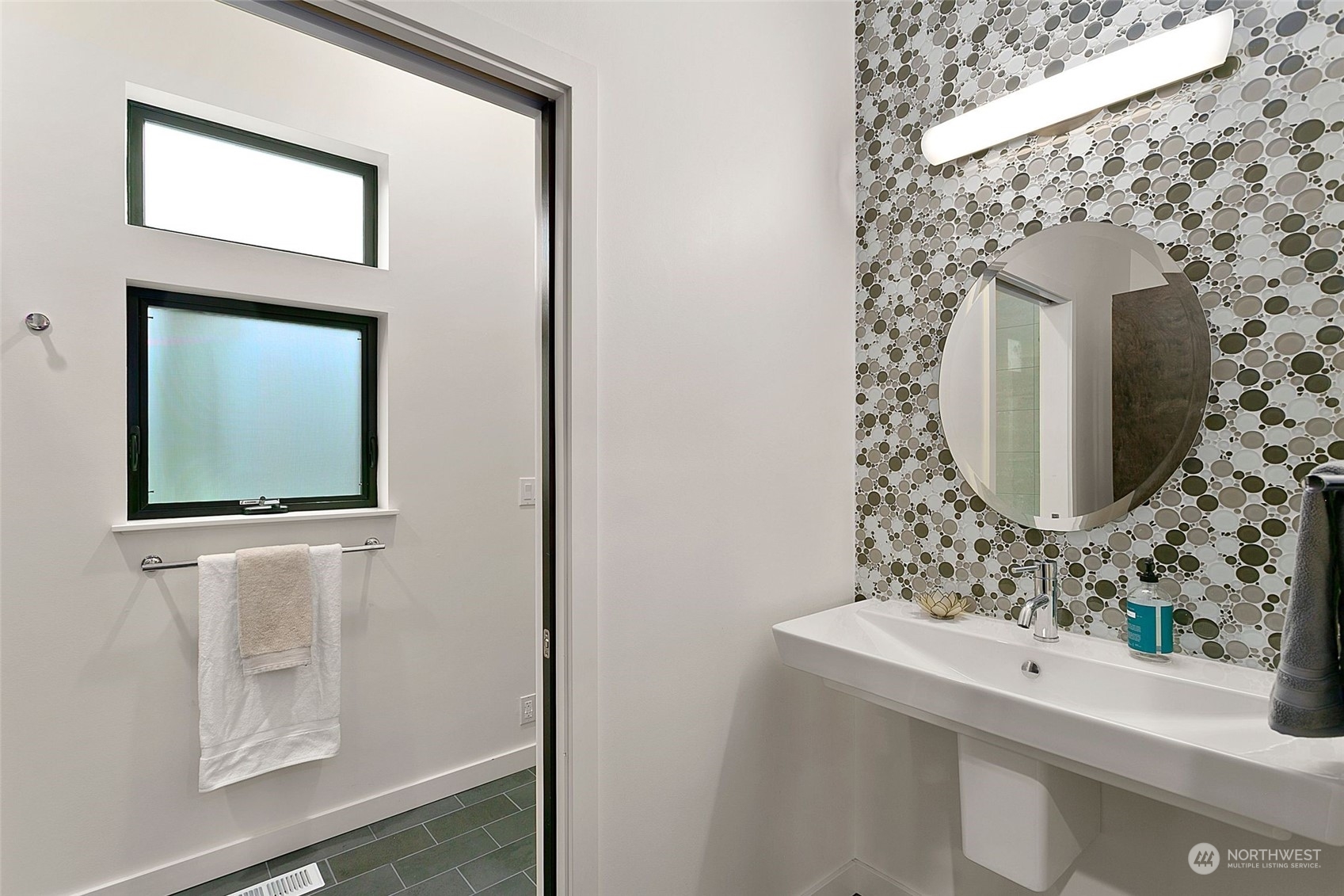 2717 36th Avenue Southwest Seattle, WA 98126 - Photo 13 of 40 a bathroom with a mirror sink and mirror