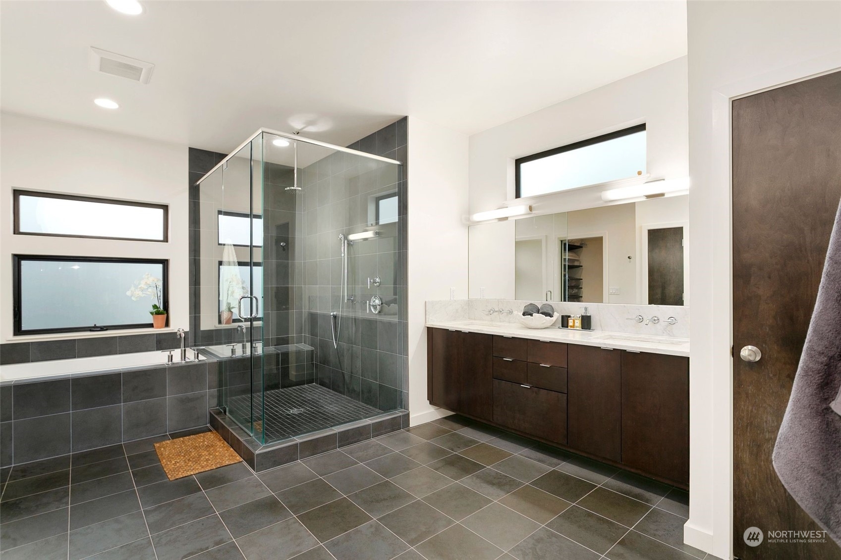 2717 36th Avenue Southwest Seattle, WA 98126 - Photo 16 of 40 a spacious bathroom with a shower a mirror and a sink