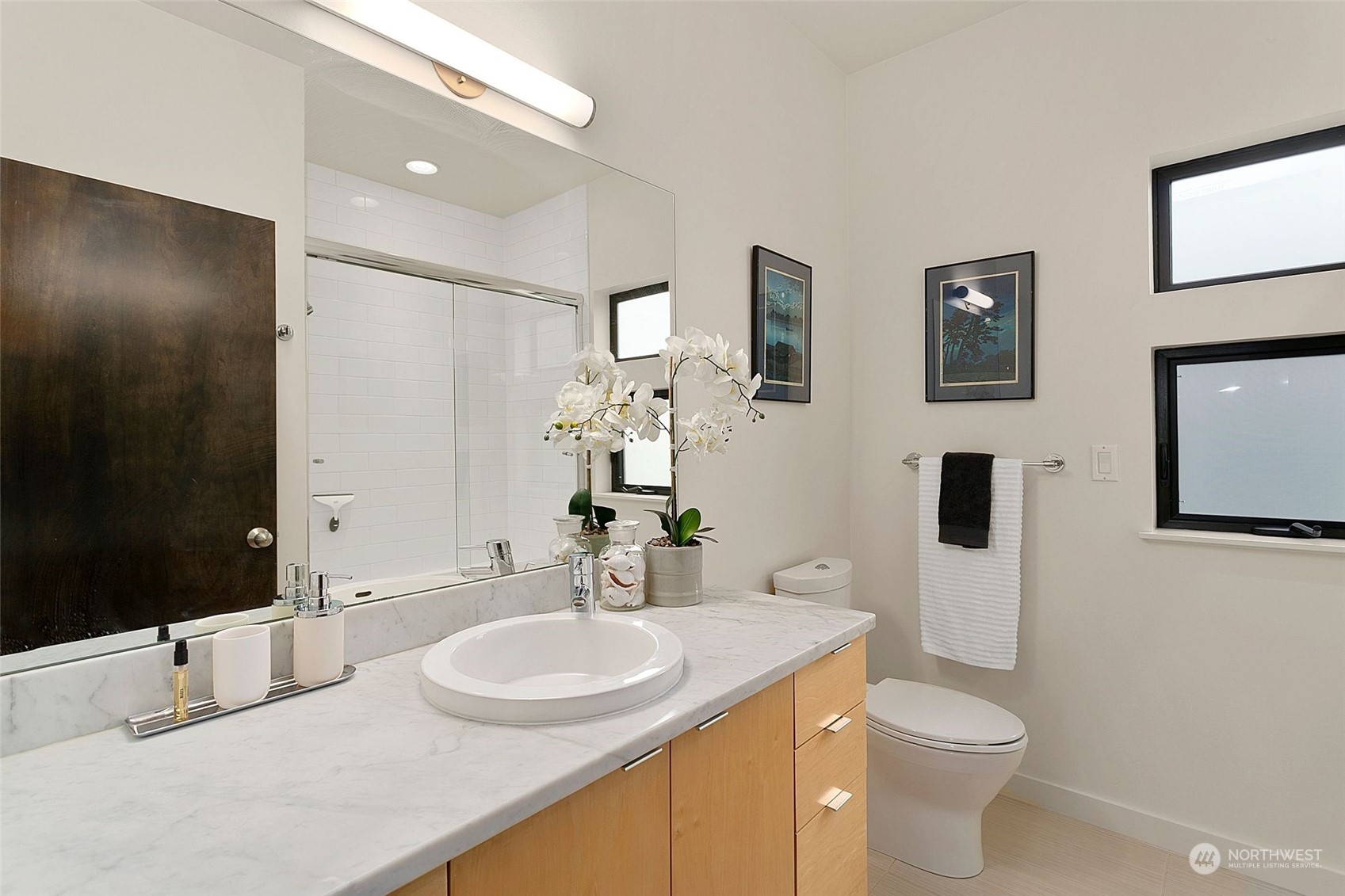 2717 36th Avenue Southwest Seattle, WA 98126 - Photo 21 of 40 a bathroom with a toilet sink and mirror