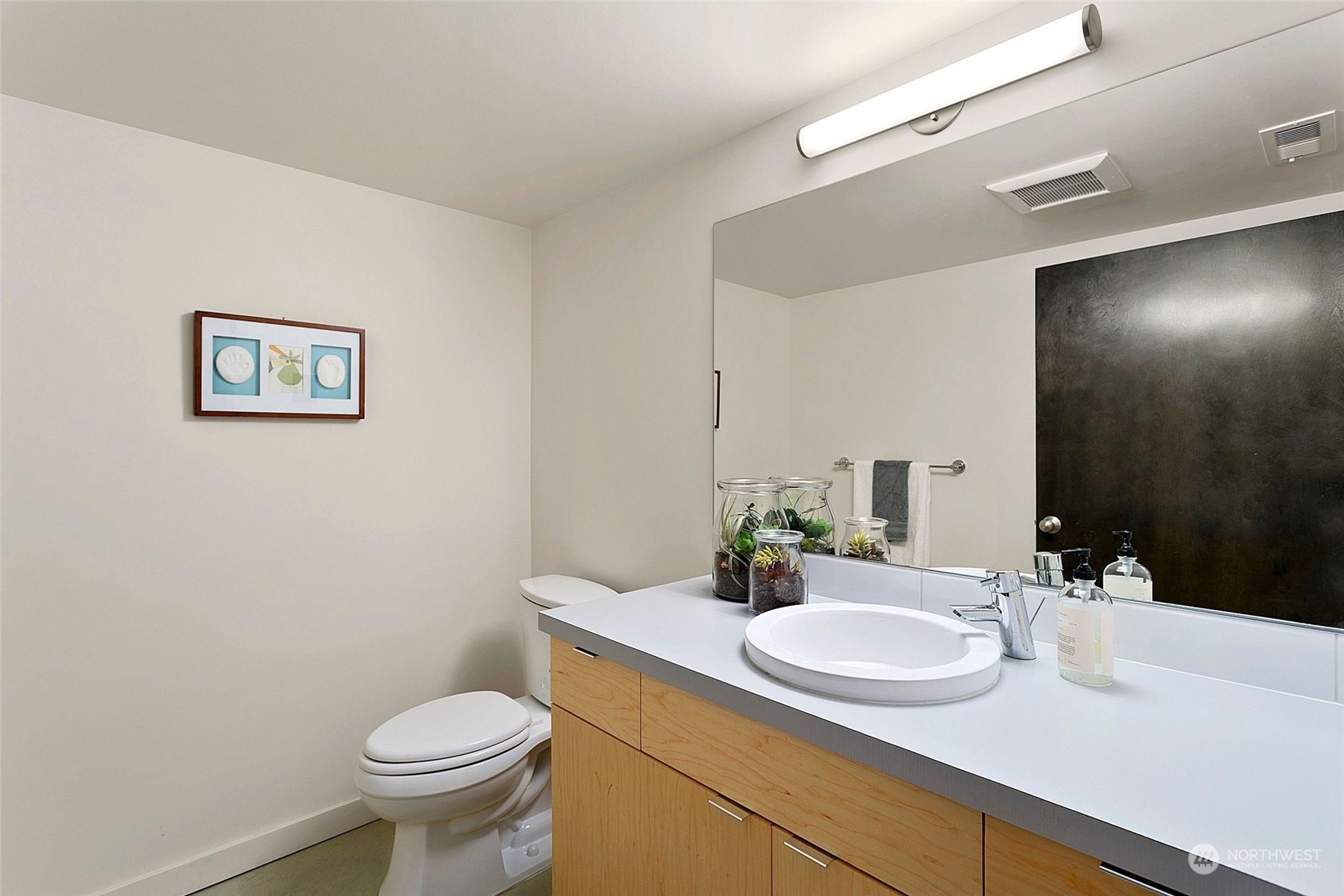 2717 36th Avenue Southwest Seattle, WA 98126 - Photo 25 of 40 a bathroom with a granite countertop sink and a mirror with toilet