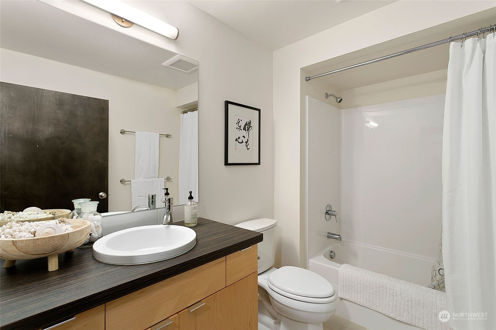 2717 36th Avenue Southwest Seattle, WA 98126 - Photo 27 of 40 a bathroom with a granite countertop sink toilet and shower