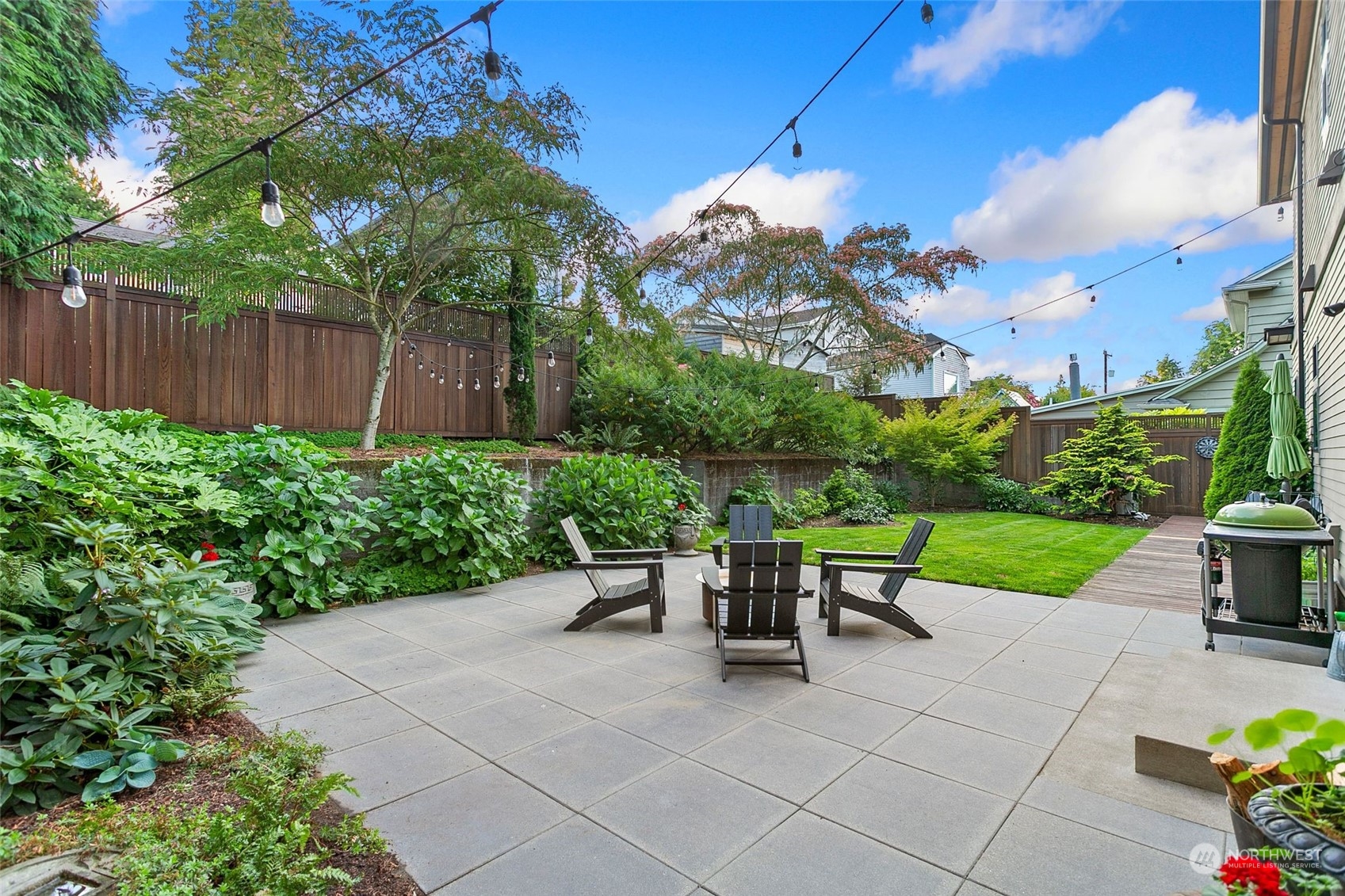 2717 36th Avenue Southwest Seattle, WA 98126 - Photo 31 of 40 a view of a table and chairs in the garden