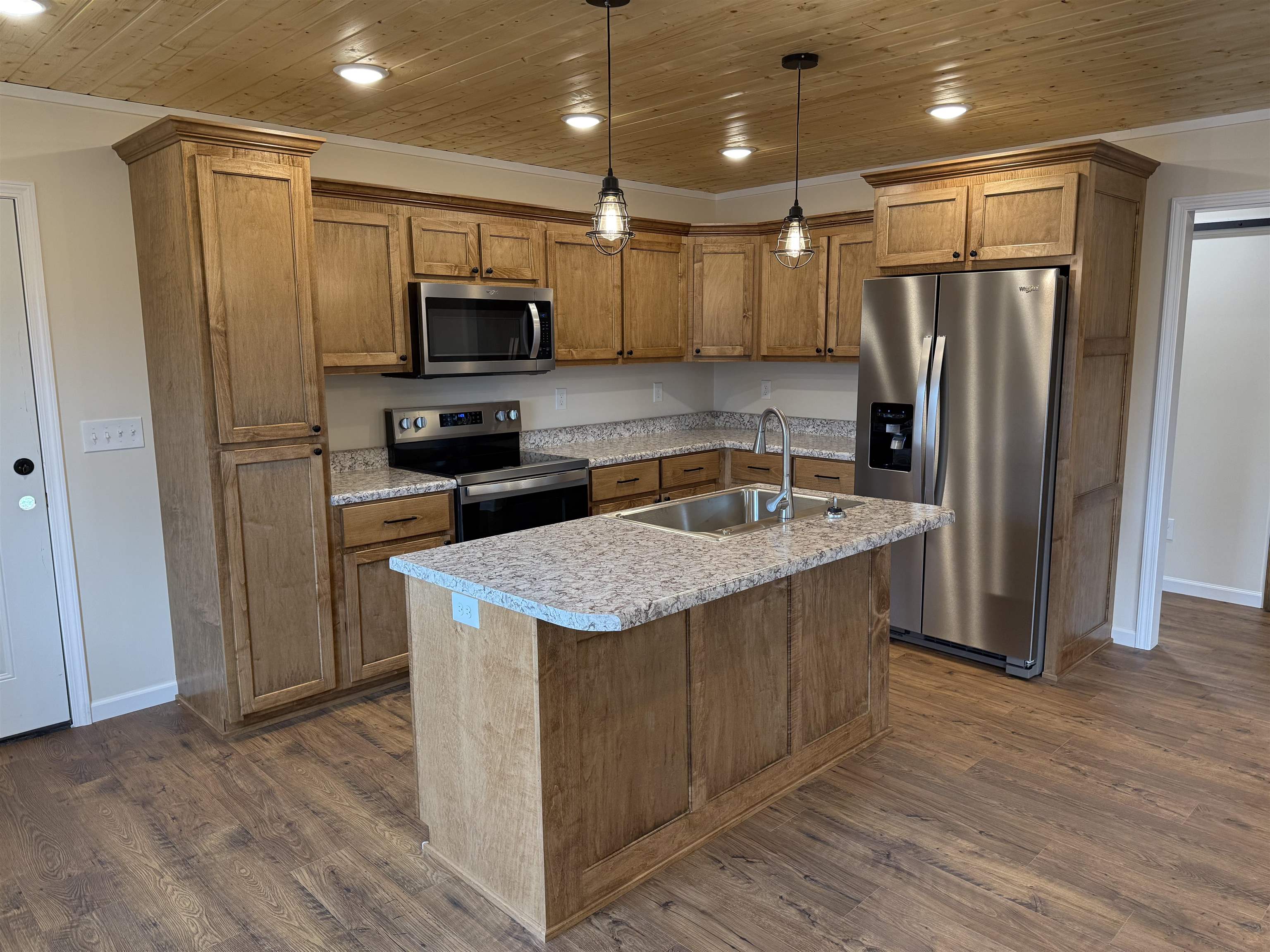 104 Young Drive Selmer, TN 38375 - Photo 2 of 12 a kitchen with stainless steel appliances granite countertop a refrigerator a sink and a stove