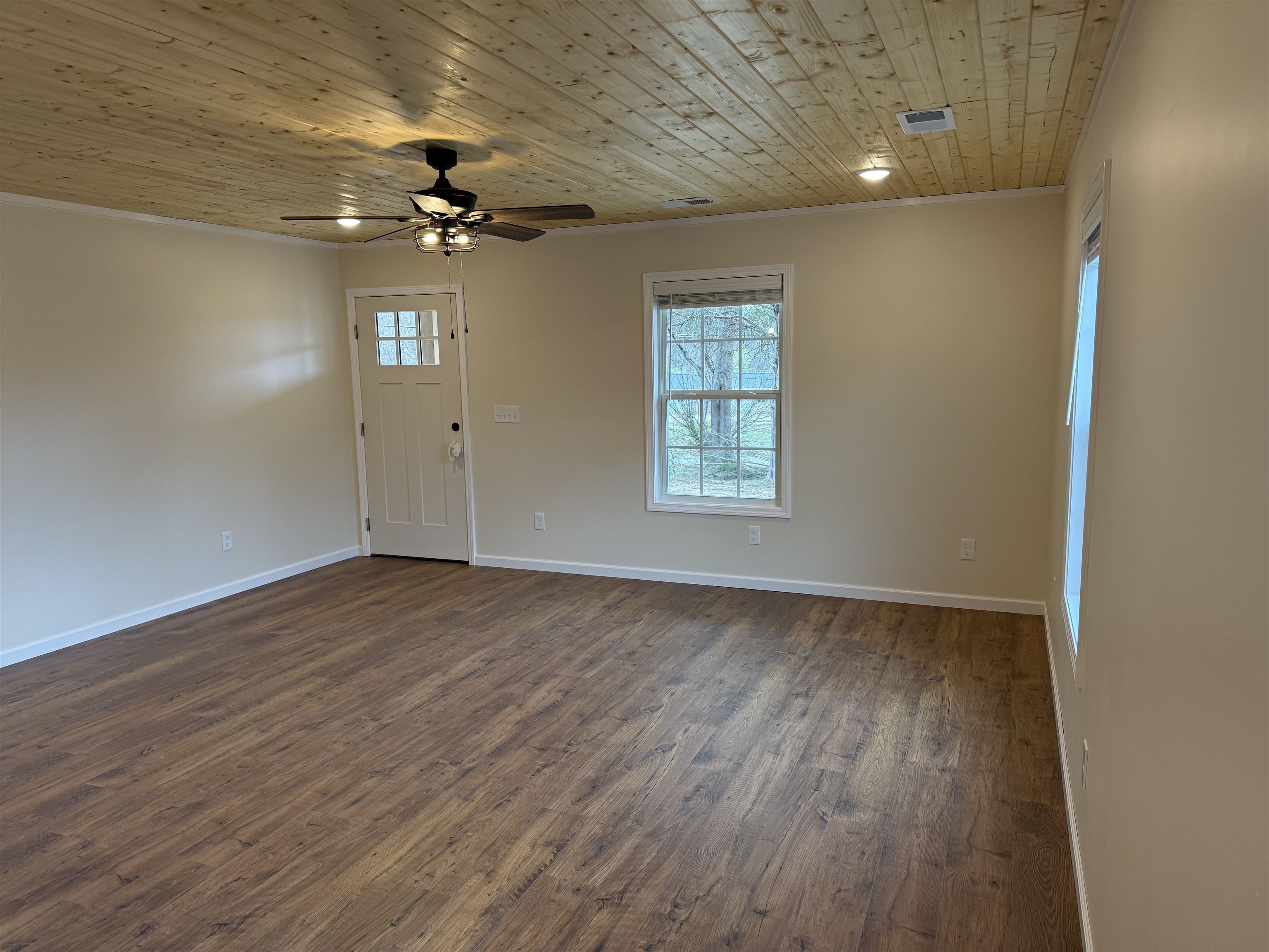 104 Young Drive Selmer, TN 38375 - Photo 3 of 12 wooden floor in an empty room with a window
