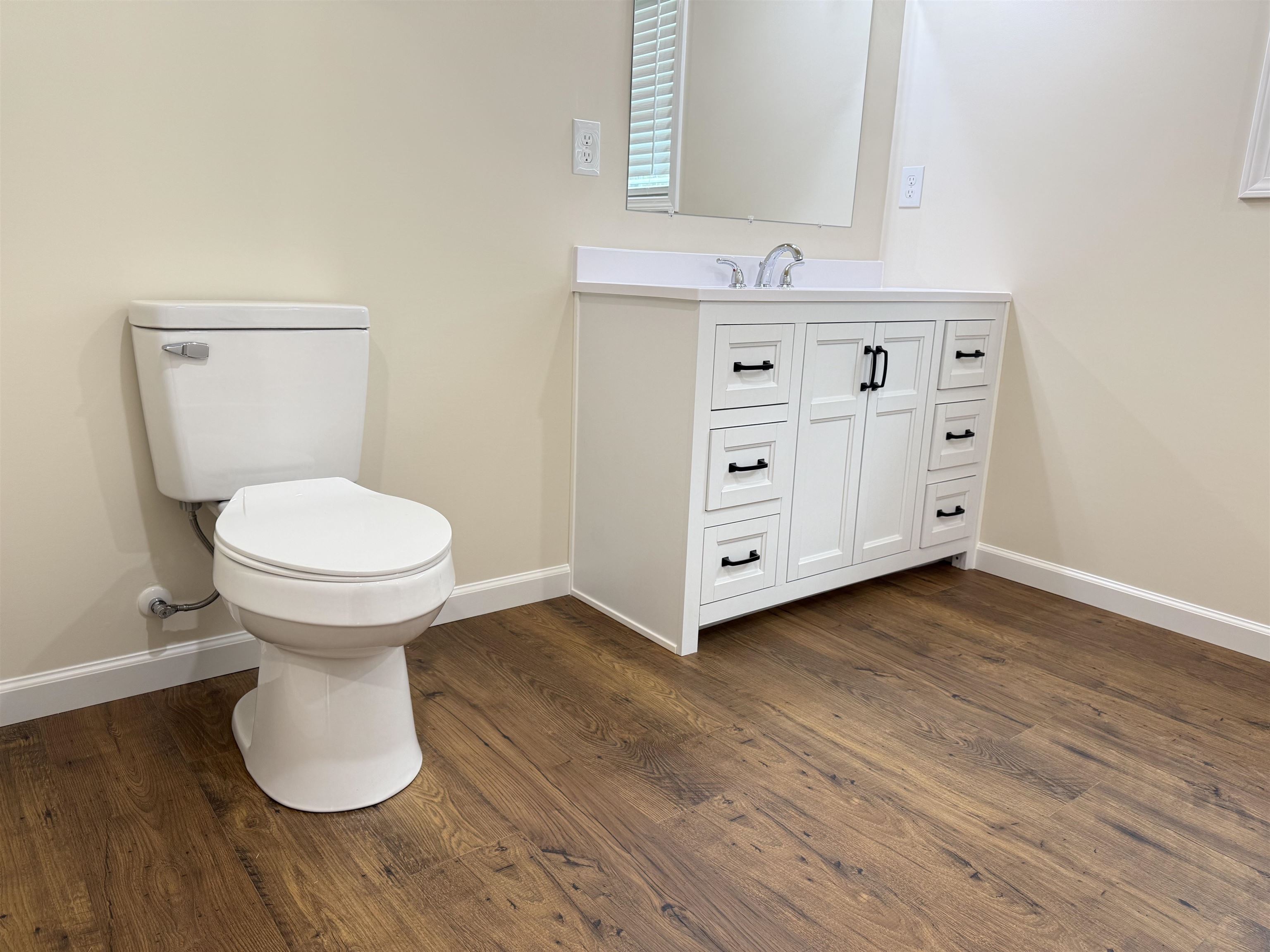 104 Young Drive Selmer, TN 38375 - Photo 7 of 12 a bathroom with a toilet sink and a mirror
