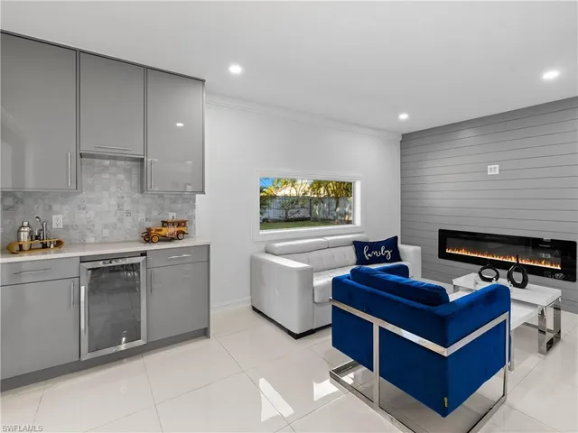 a living room with furniture a fireplace and a piano