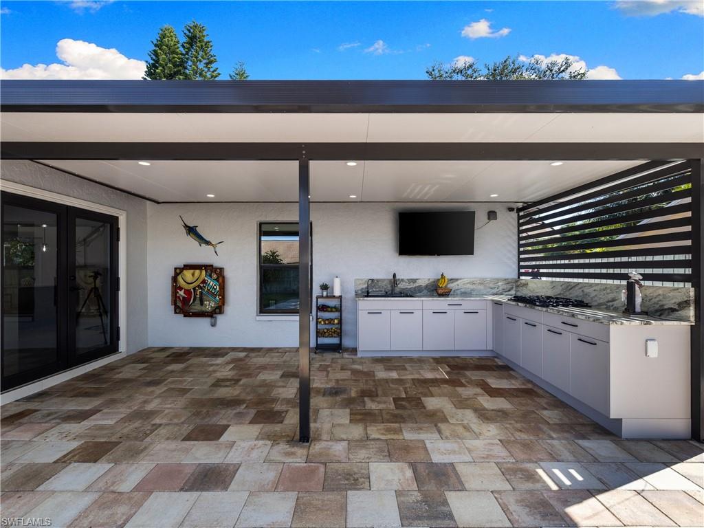 1837 51st Terrace Southwest Naples, FL 34116 - Photo 17 of 35 View of patio featuring exterior kitchen: 5 burner gas range, deep single basin sink, insulated roof