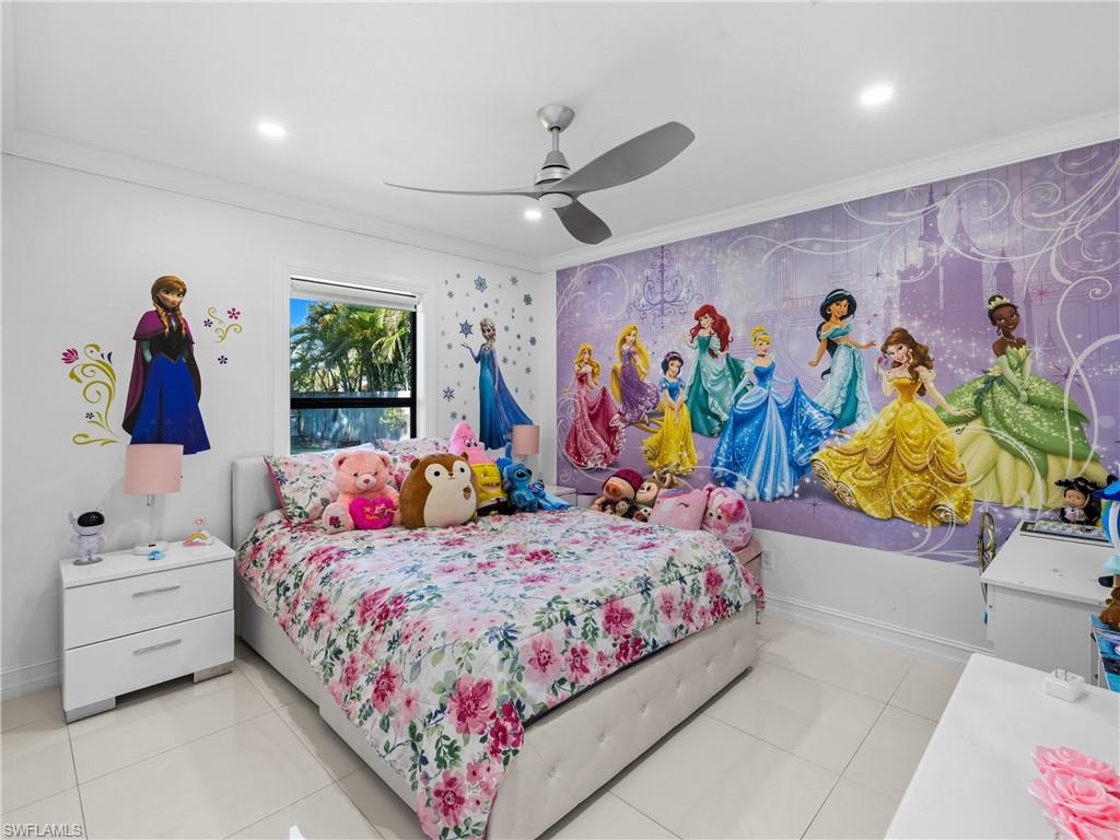 1837 51st Terrace Southwest Naples, FL 34116 - Photo 19 of 35 Bedroom featuring crown molding, light tile patterned floors, a ceiling fan, recessed lighting, custom built in closet