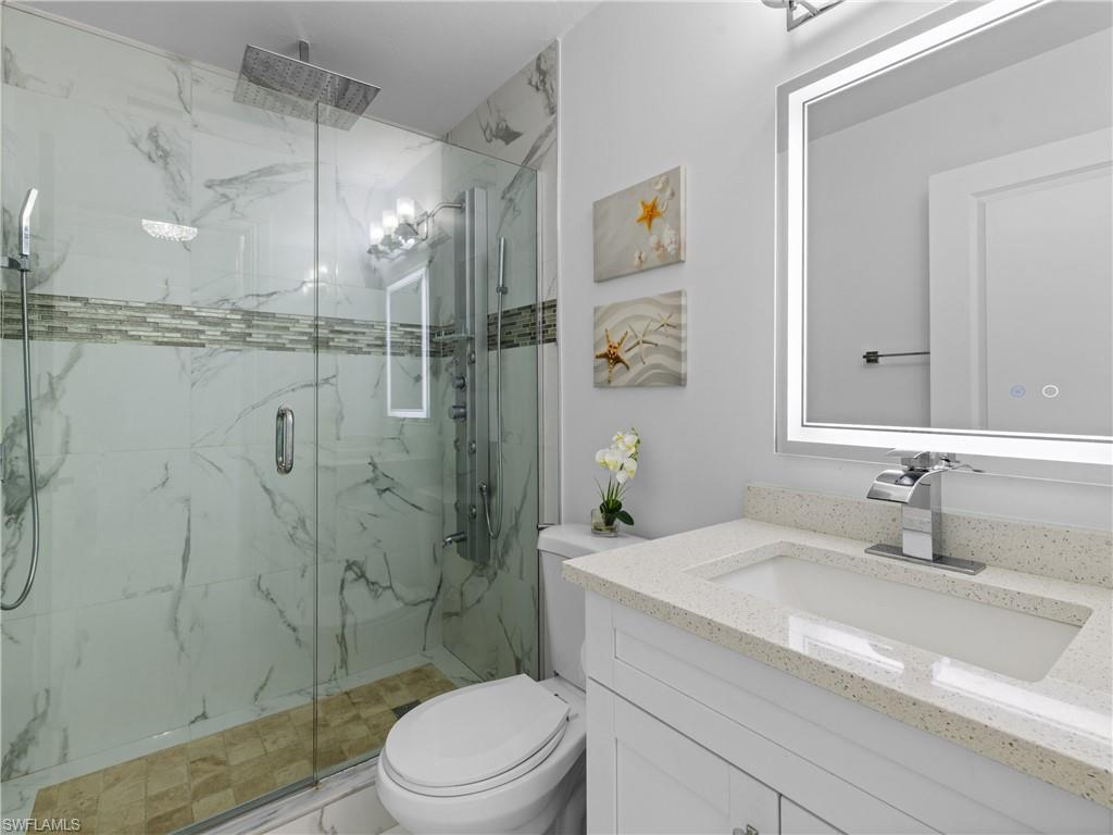 1837 51st Terrace Southwest Naples, FL 34116 - Photo 20 of 35 Full bath with vanity and a marble finish shower