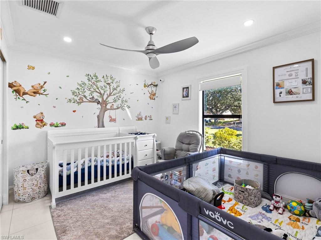1837 51st Terrace Southwest Naples, FL 34116 - Photo 21 of 35 Bedroom featuring crown molding, light tile patterned floors, a ceiling fan, recessed lighting, custom built in closet