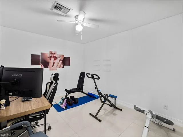 a view of a workspace with furniture and a gym