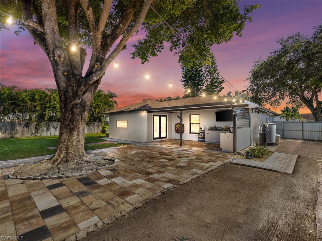 1837 51st Terrace Southwest Naples, FL 34116 - Photo 34 of 35 Ranch-style home featuring stucco siding, area for grilling, and a patio