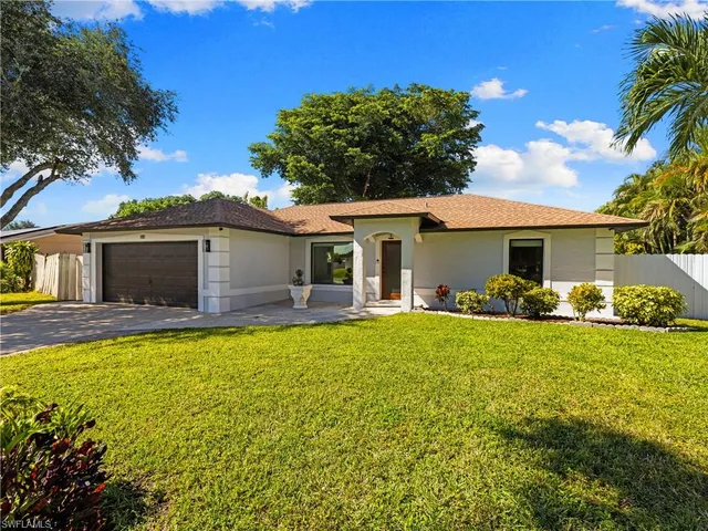 a front view of a house with swimming pool having outdoor seating
