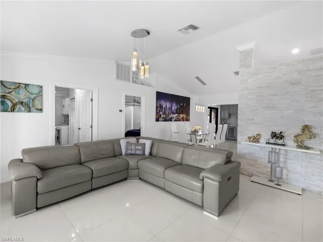 a living room with furniture and view of kitchen