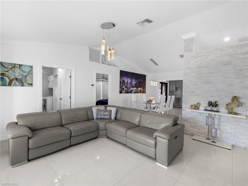 1837 51st Terrace Southwest Naples, FL 34116 - Photo 4 of 35 Living area features: picture window, vaulted ceiling, crown molding and recessed lights.