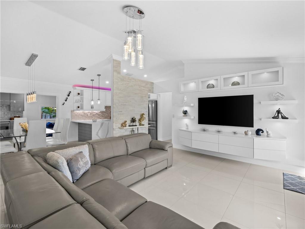 1837 51st Terrace Southwest Naples, FL 34116 - Photo 5 of 35 Living area features: picture window, vaulted ceiling, crown molding and recessed lights, custom built in entertainment center.
