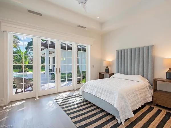 a bedroom with a large bed and a large window