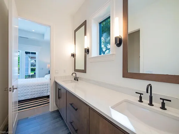 a bathroom with a double vanity sink and mirror