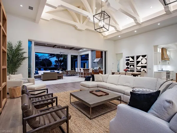a living room with furniture and a chandelier