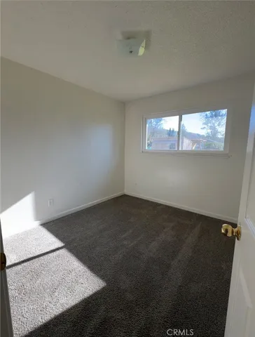 a view of empty room with ceiling fan