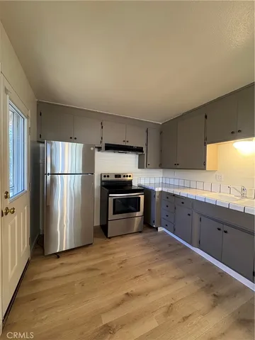 a kitchen with stainless steel appliances a refrigerator and a sink