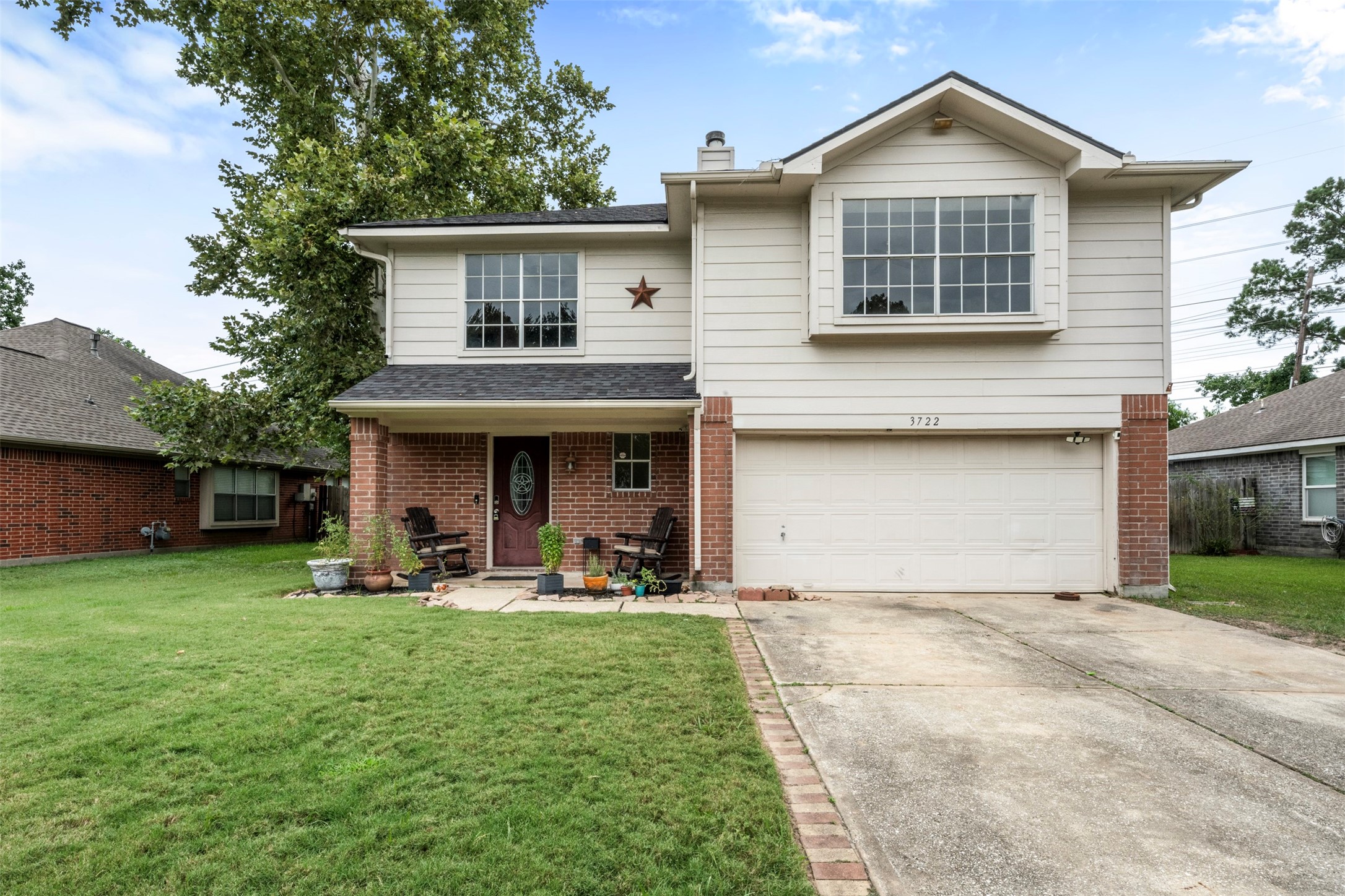 Beautiful two-story home with welcoming curb appeal and mature landscaping.