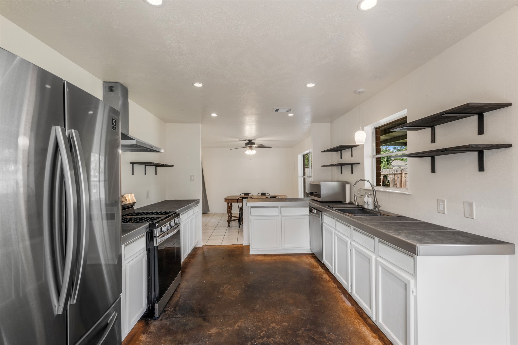 3722 Oaklace Drive Spring, TX 77389 - Photo 10 of 25 Bright kitchen featuring stainless appliances and functional layout.