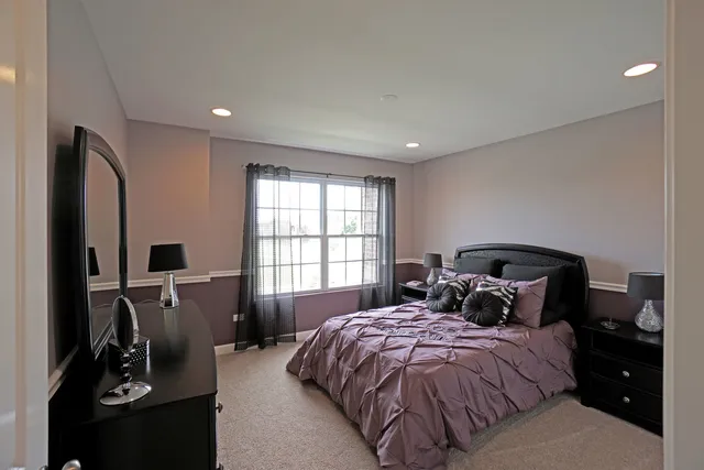 a bedroom with a bed and a tv