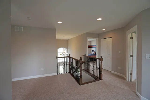 a view of a hallway with a livingroom and dining room view
