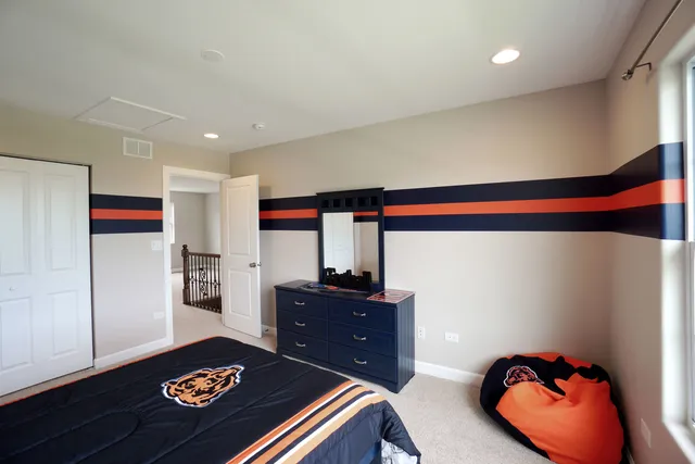 a room with a bed and a dresser