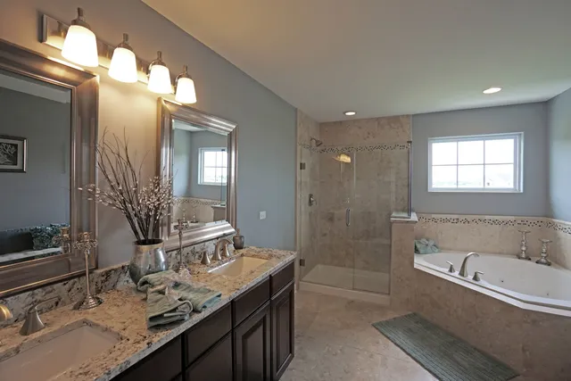 a bathroom with a granite countertop sink a toilet a mirror and shower