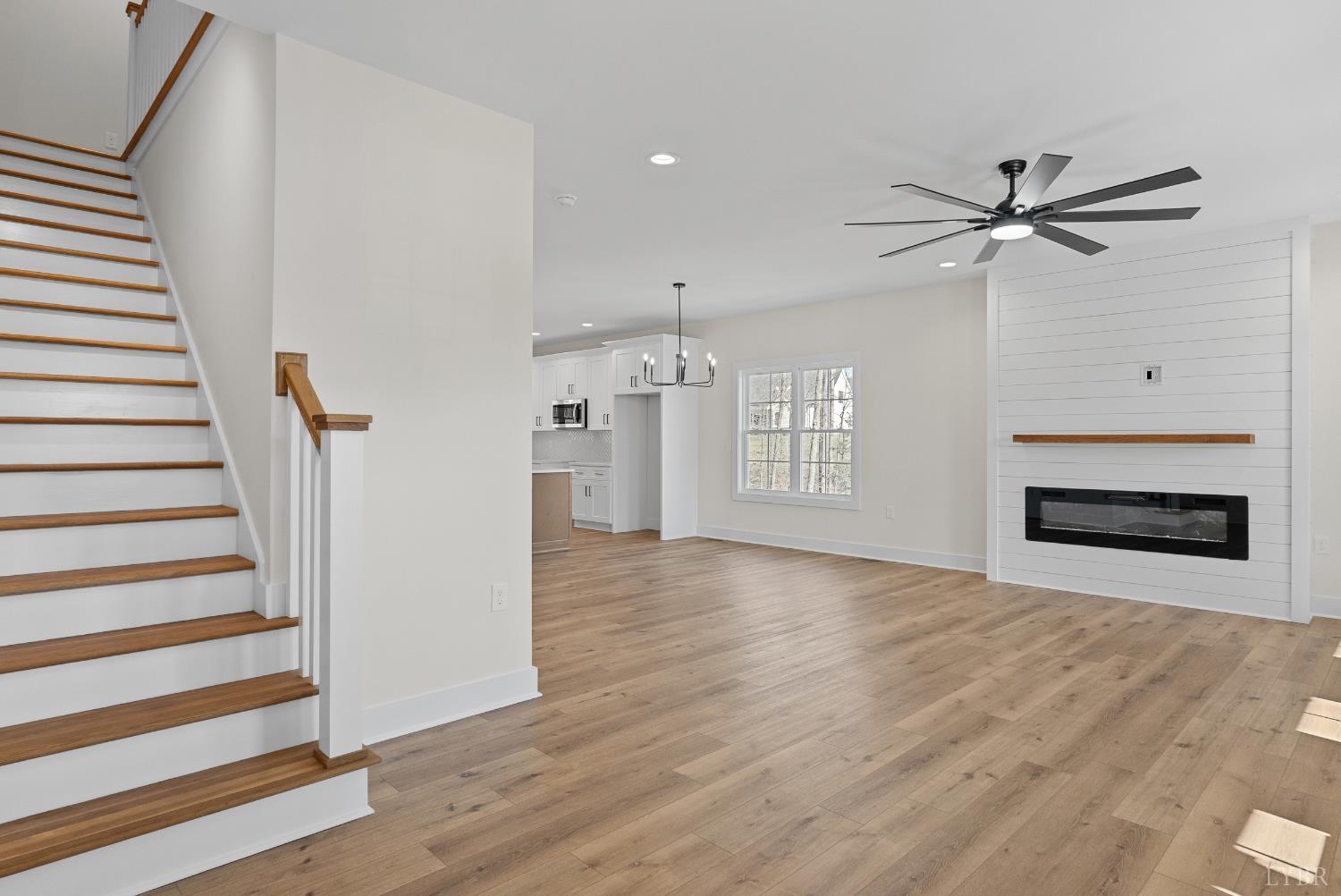 wooden floor in an empty room with a fireplace