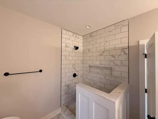 a white toilet sitting next to a white sink