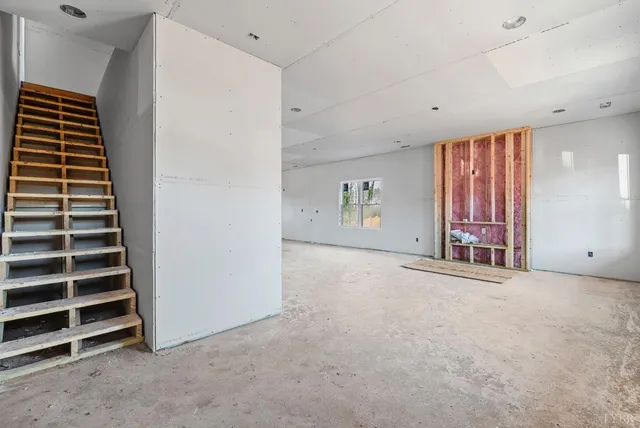 an empty room with windows and garden