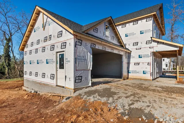 a view of a house with a yard covered in snow
