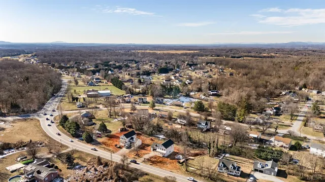 an aerial view of residential houses and outdoor space