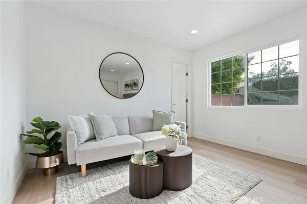 a living room with furniture potted plant and a window