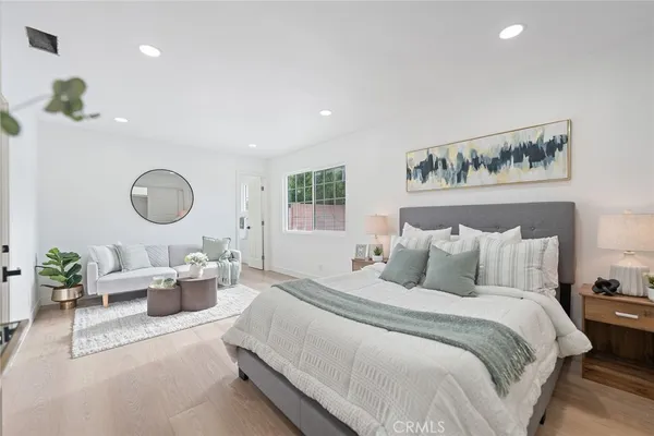 a bedroom with bed and a chandelier