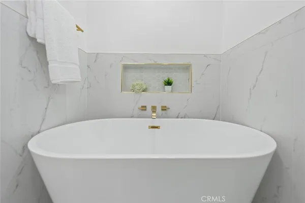 a white bath tub sitting in a bathroom